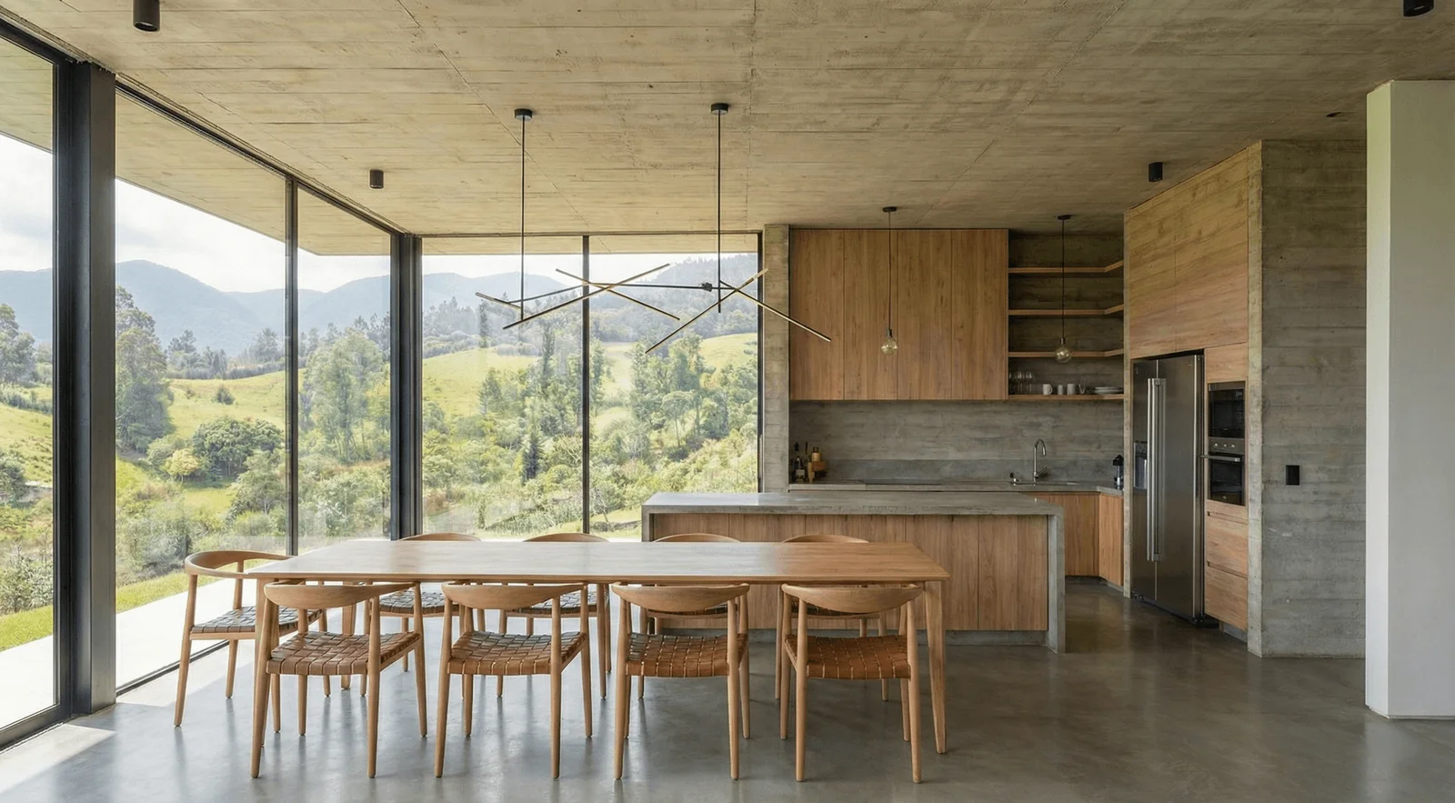 Comedor y cocina de concreto y madera con ventanales y vista a las montañas