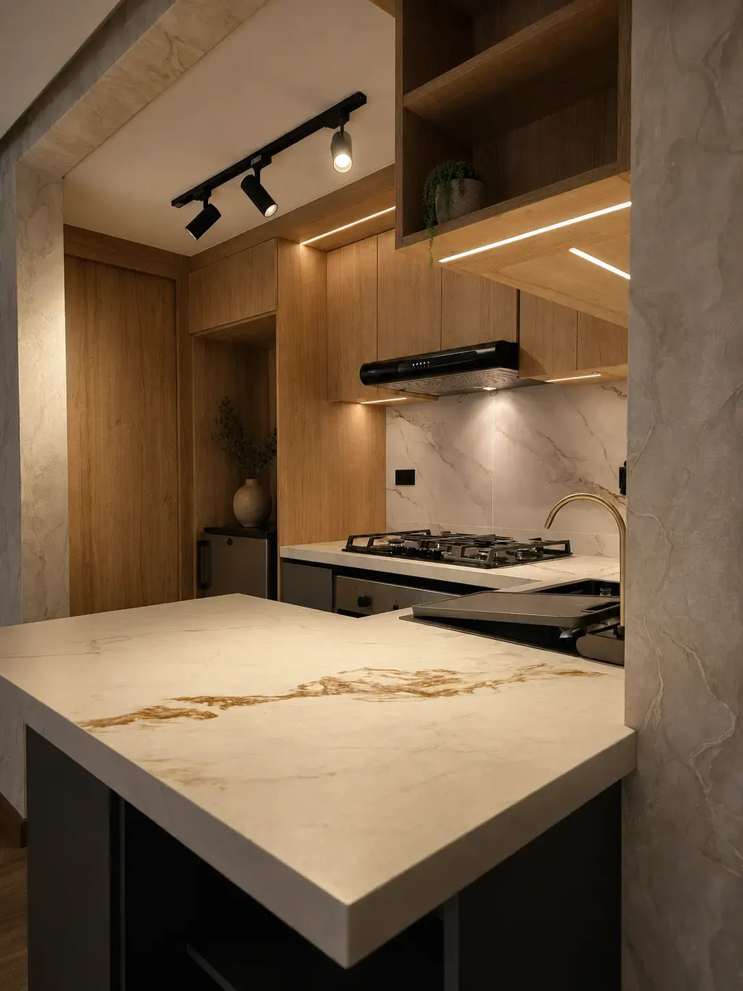Mesón de porcelanato veteado con vista a la cocina y la campana