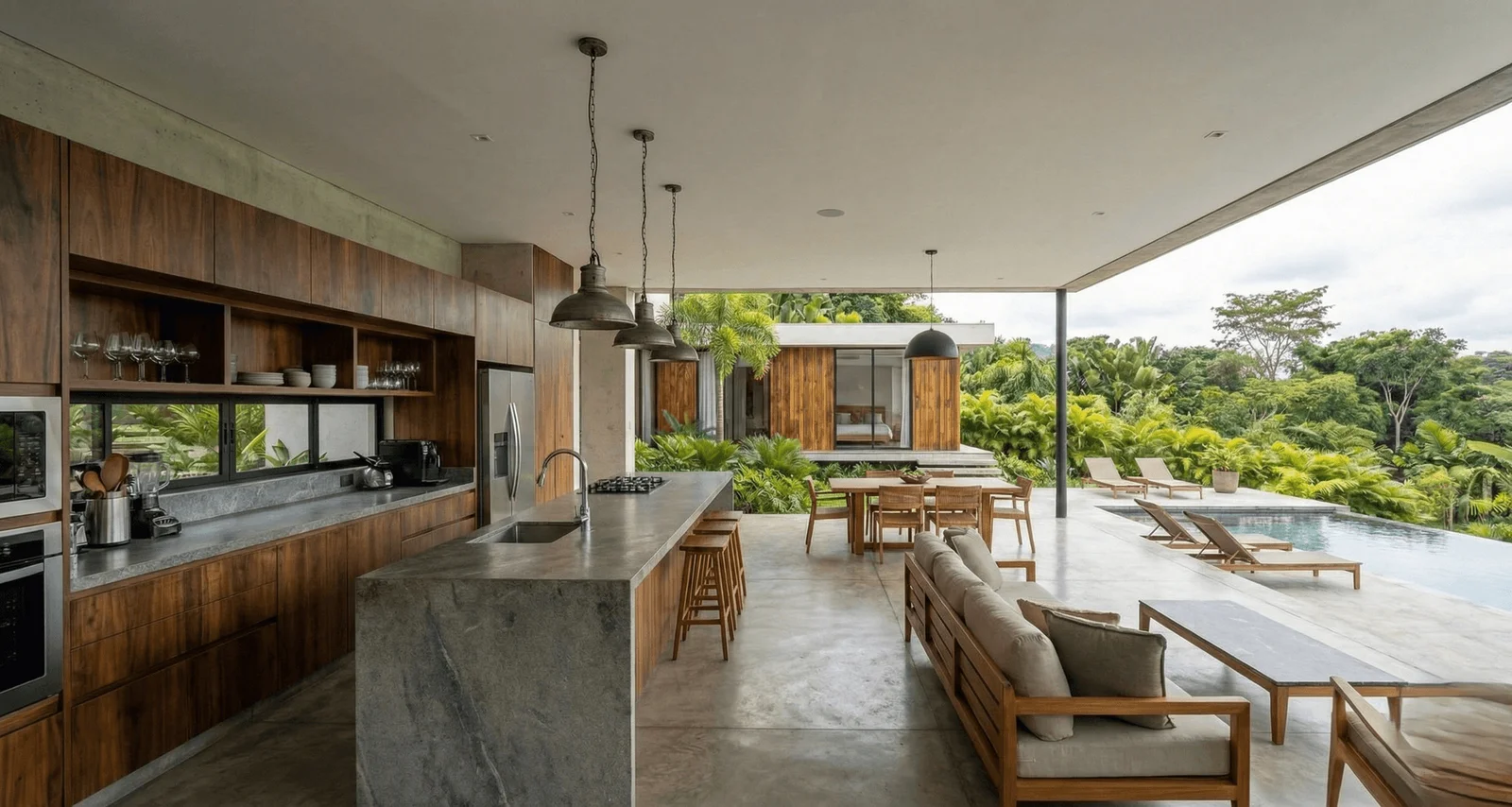 Cocina y zona social abierta con vista a la piscina y la vegetación