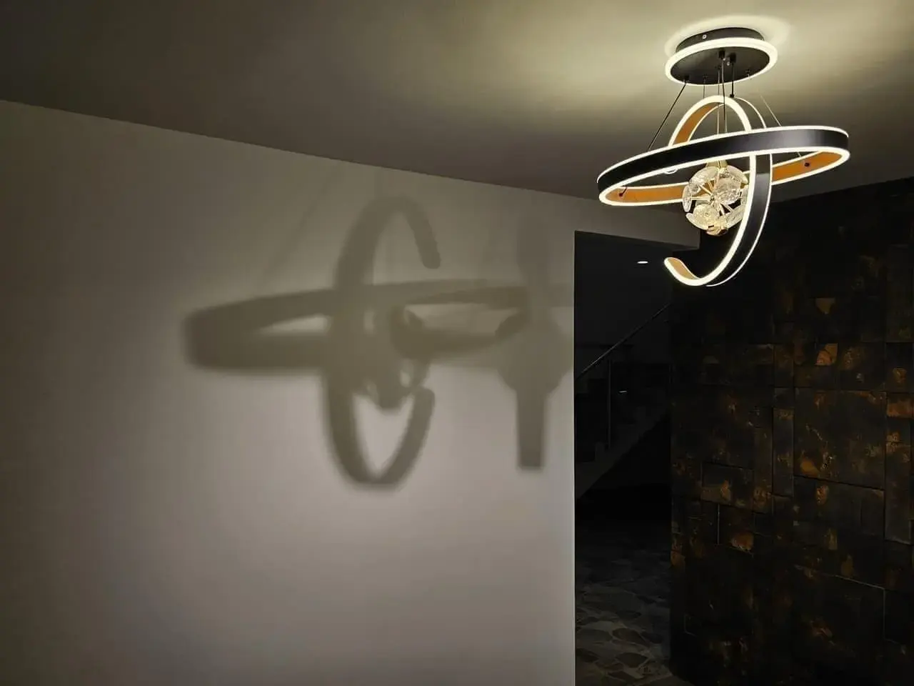 Lámpara de techo de diseño y su sombra proyectada en la pared